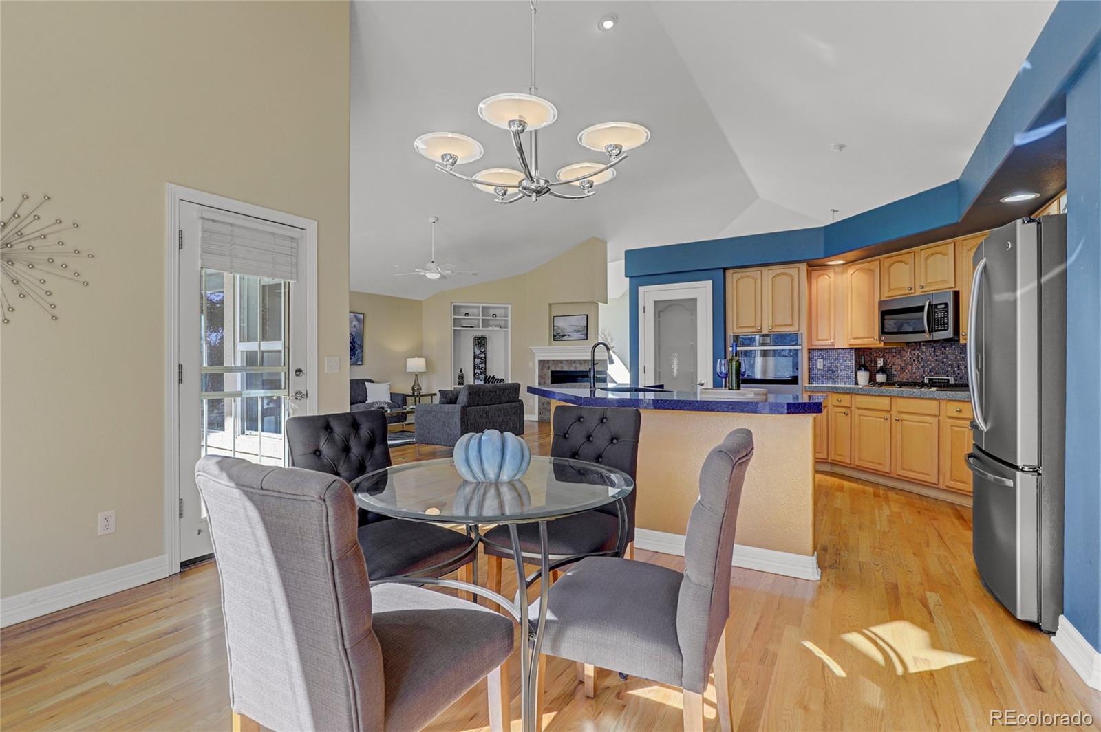 13810 Muirfield Circle Broomfield, CO 80023 - Photo 19 of 45 a dining room with furniture a kitchen view and a chandelier
