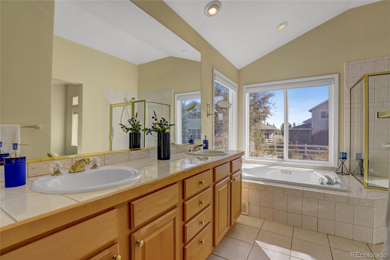 13810 Muirfield Circle Broomfield, CO 80023 - Photo 25 of 45 a bathroom with a tub sink and mirror
