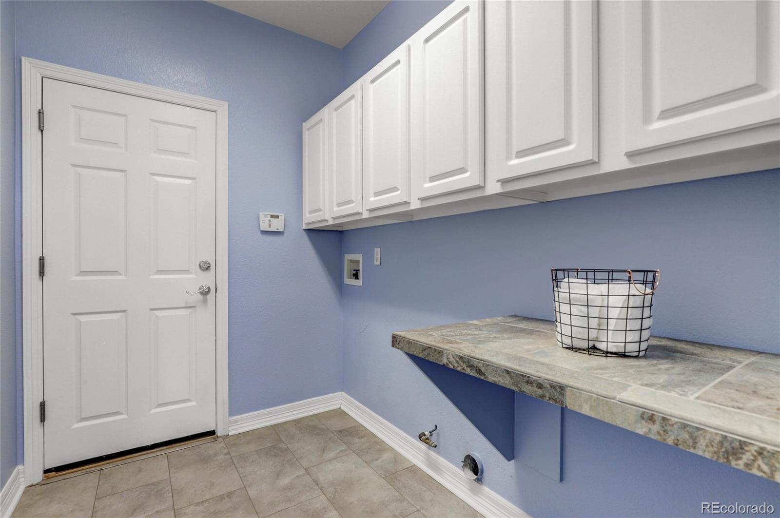 13810 Muirfield Circle Broomfield, CO 80023 - Photo 27 of 45 a kitchen with granite countertop white cabinets and sink