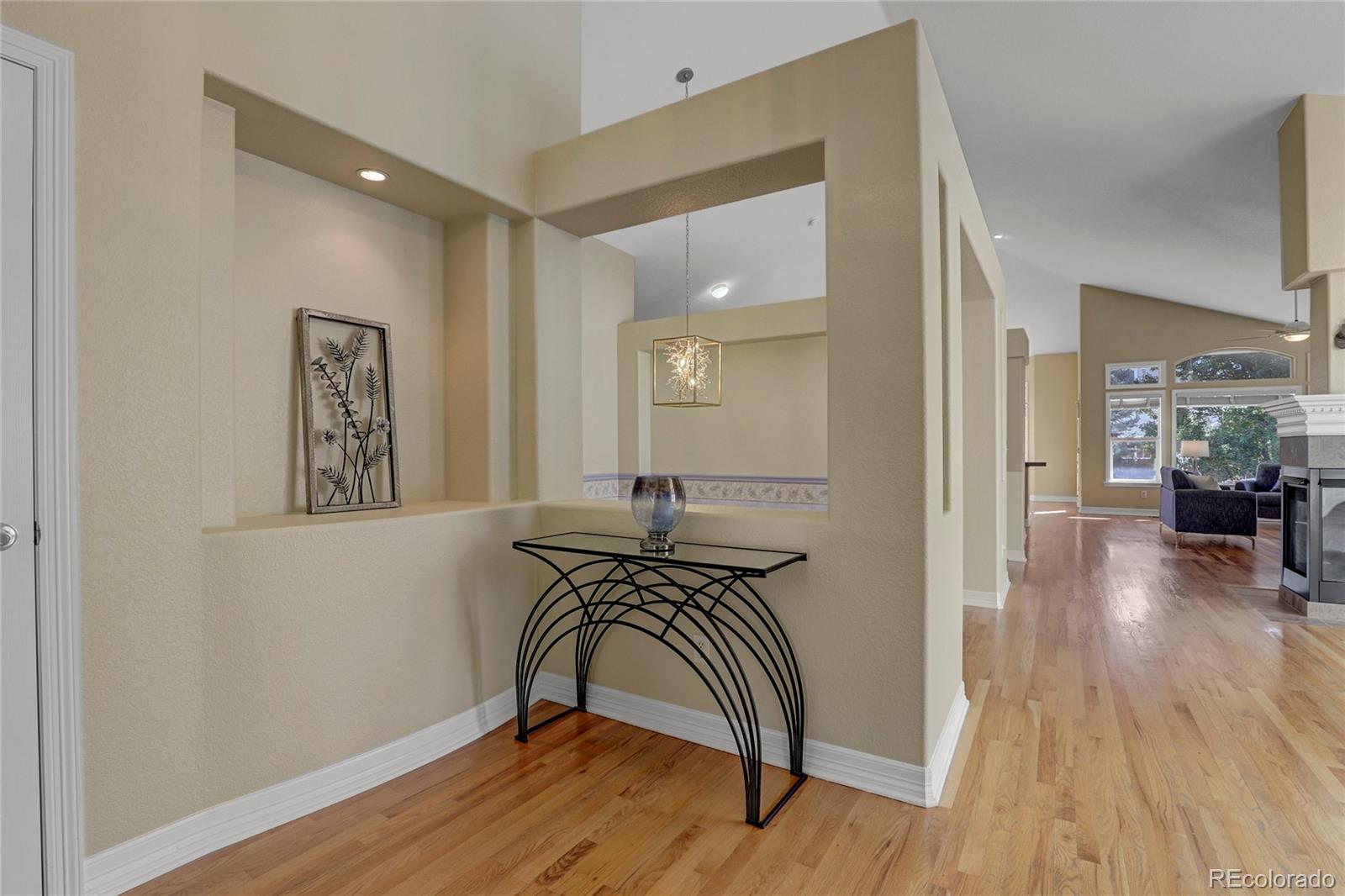 13810 Muirfield Circle Broomfield, CO 80023 - Photo 3 of 45 a view of a hallway with wooden floor and furniture