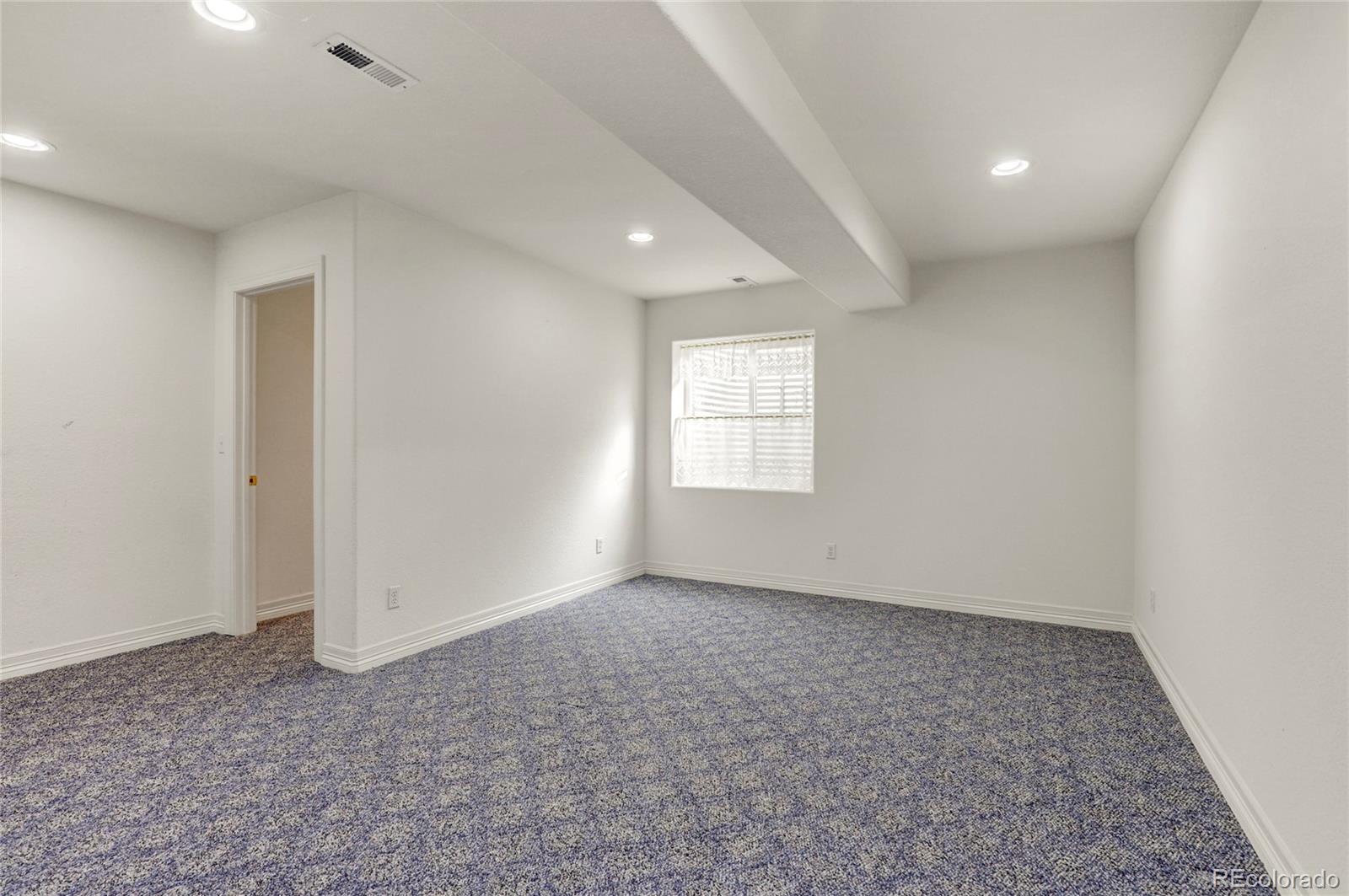 13810 Muirfield Circle Broomfield, CO 80023 - Photo 38 of 45 an empty room with windows