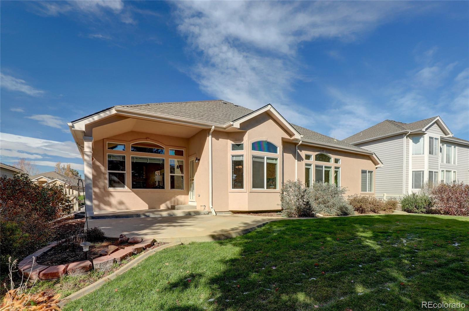 13810 Muirfield Circle Broomfield, CO 80023 - Photo 43 of 45 a front view of a house with a yard