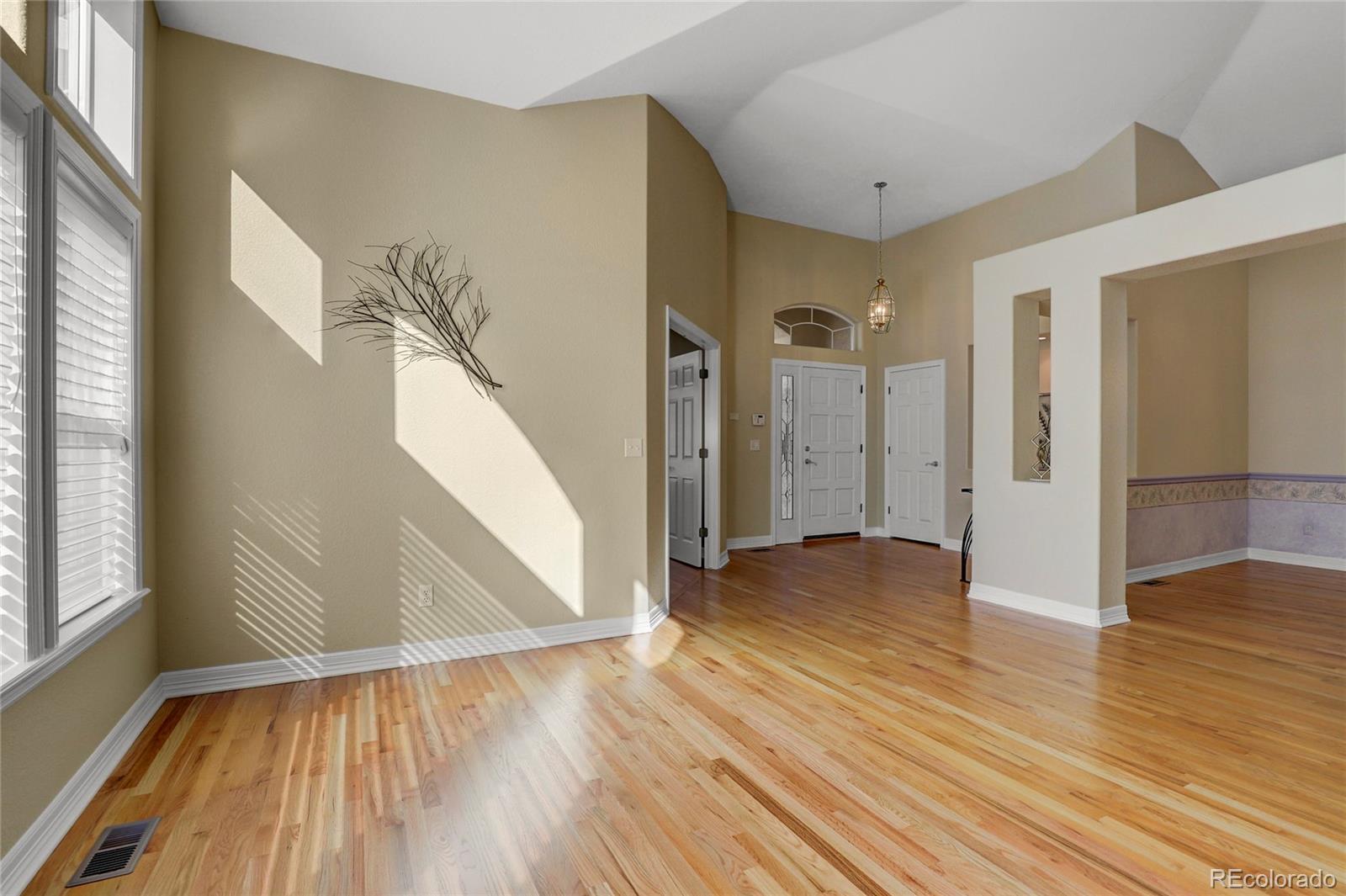 13810 Muirfield Circle Broomfield, CO 80023 - Photo 9 of 45 a view of empty room with wooden floor and fan