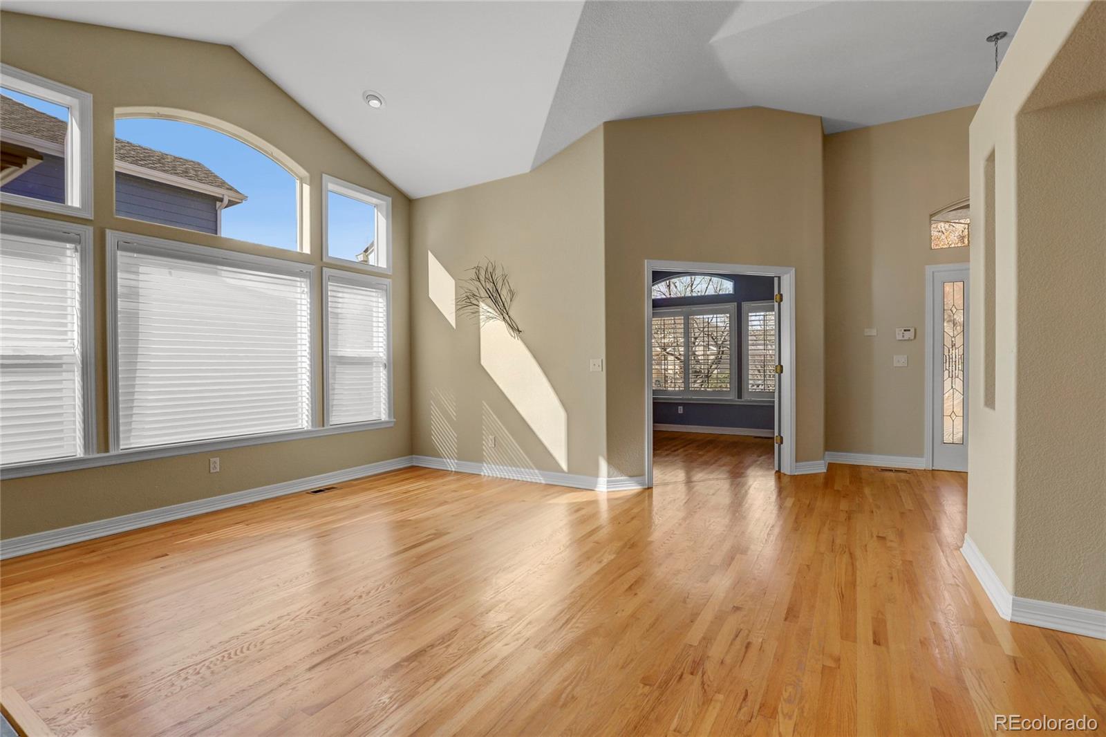 13810 Muirfield Circle Broomfield, CO 80023 - Photo 10 of 45 a view of an empty room with window and wooden floor