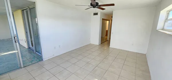 a view of a hallway to rooms and stairs