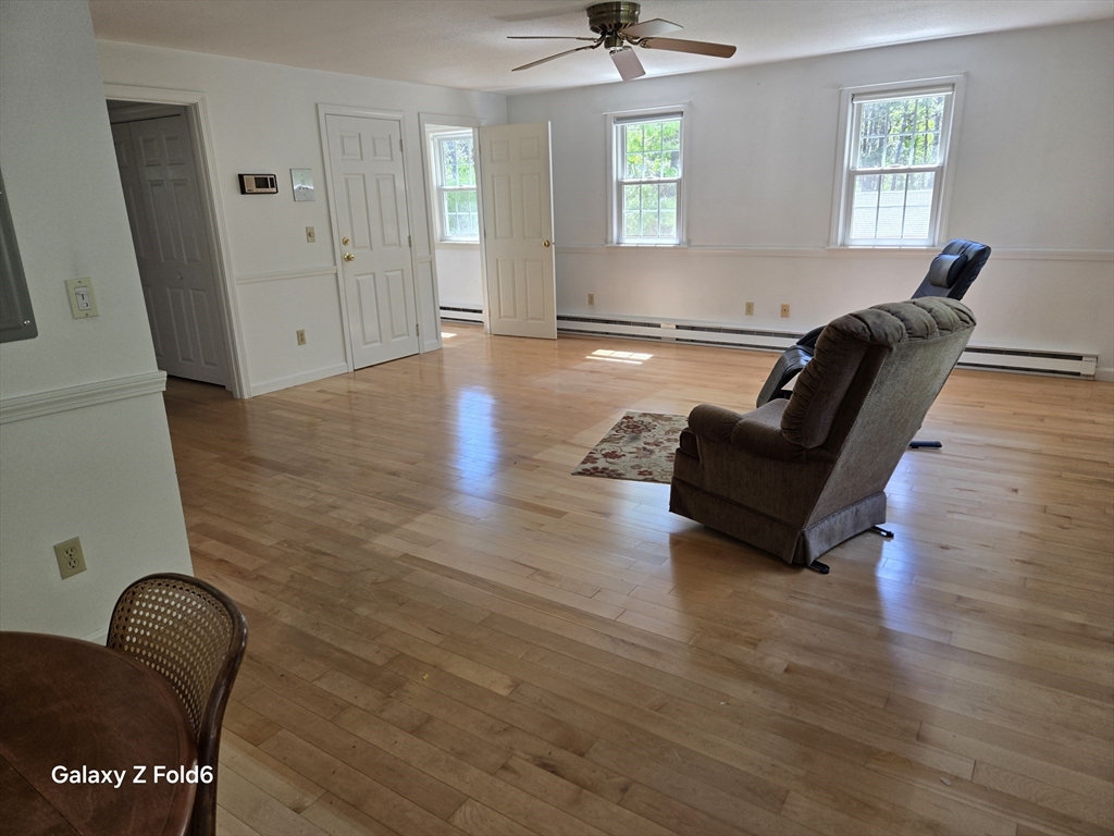222 Buck Island Road, Unit 45 Yarmouth, MA 02673 - Photo 6 of 23 a living room with furniture and wooden floor