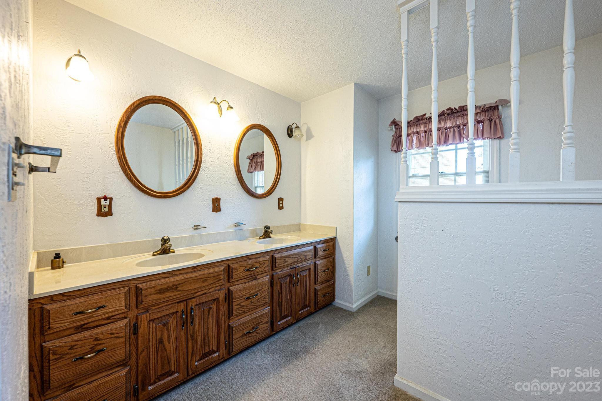 837 White Plains Road Hiddenite, NC 28636 - Photo 22 of 46 a bathroom with a double vanity sink and a mirror