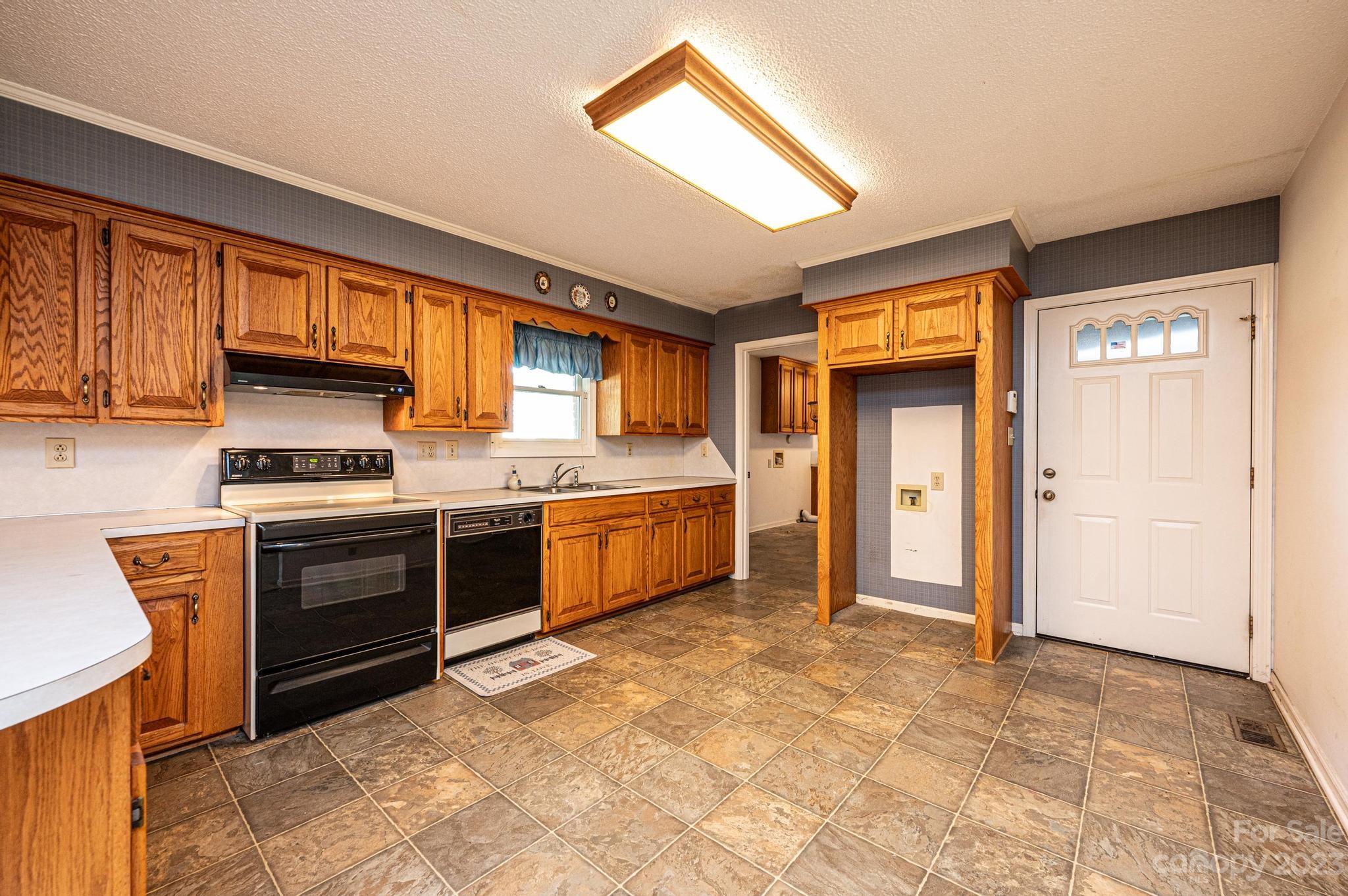 837 White Plains Road Hiddenite, NC 28636 - Photo 24 of 46 a kitchen with stainless steel appliances and cabinets