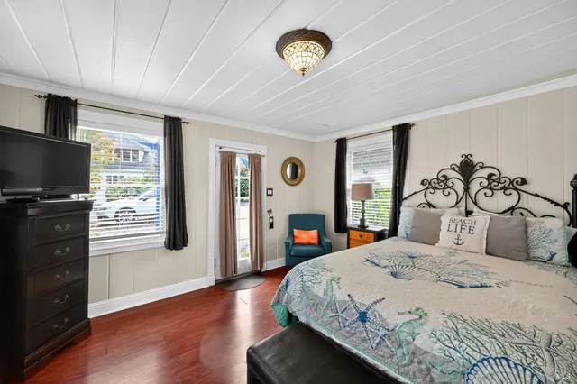 a large bed sitting in a bedroom next to a window