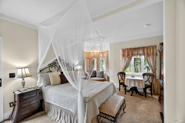 a bedroom with a bed and a chandelier