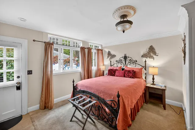 a bed sitting in a bedroom next to a window