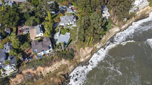 an aerial view of a house with swimming pool garden and patio