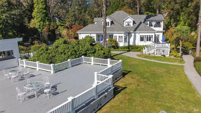 a aerial view of a house with a yard basket ball court and outdoor seating