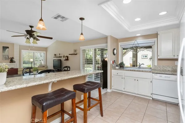 a kitchen with granite countertop sink and stove