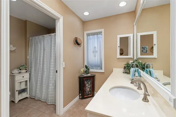 a bathroom with a tub sink and mirror