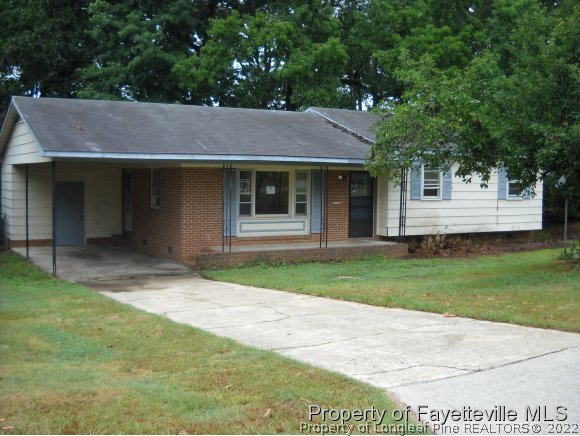 438 Lansdowne Road Fayetteville, NC 28314 - Photo 1 of 14 a front view of a house with a garden and yard
