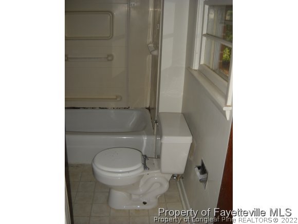 438 Lansdowne Road Fayetteville, NC 28314 - Photo 14 of 14 a white toilet sitting next to a shower