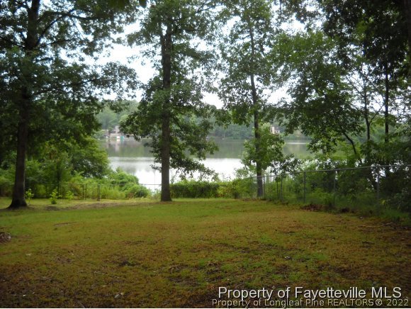 438 Lansdowne Road Fayetteville, NC 28314 - Photo 6 of 14 a view of a field with an trees