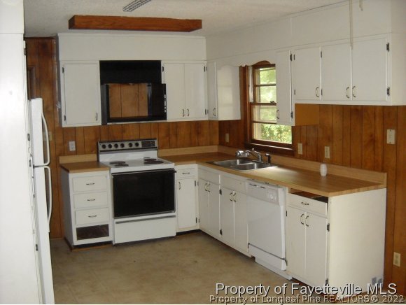 438 Lansdowne Road Fayetteville, NC 28314 - Photo 8 of 14 a kitchen with granite countertop a sink a stove and cabinets