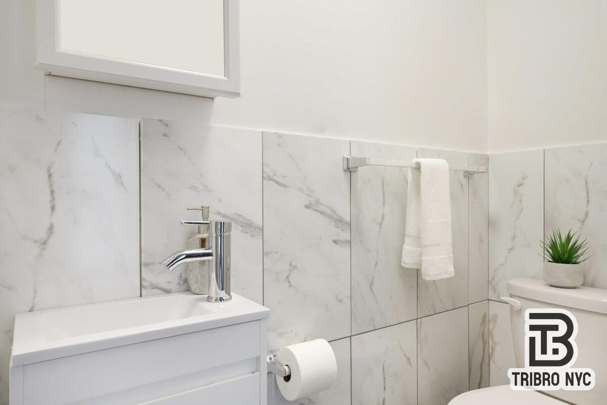 47 Market Street, Unit 3A Manhattan, NY 10002 - Photo 8 of 8 a bathroom with a sink a toilet and shower