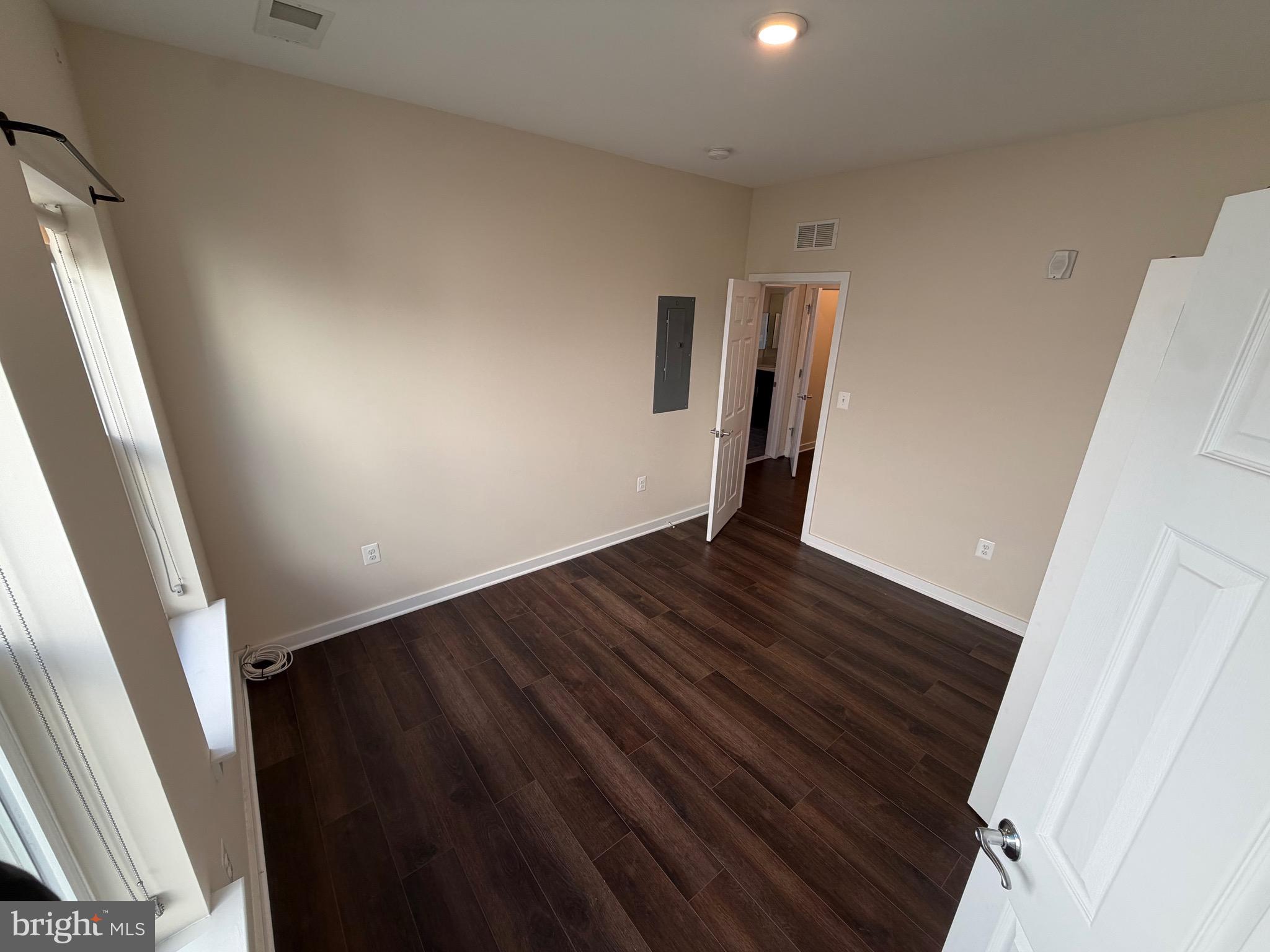 3303 Demirel Way, Unit D Ellicott City, MD 21042 - Photo 20 of 34 a view of an empty room with wooden floor and stairs
