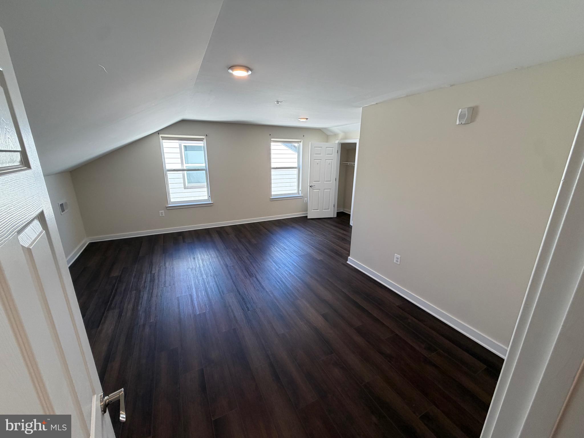 3303 Demirel Way, Unit D Ellicott City, MD 21042 - Photo 29 of 34 a view of an empty room with wooden floor and a window