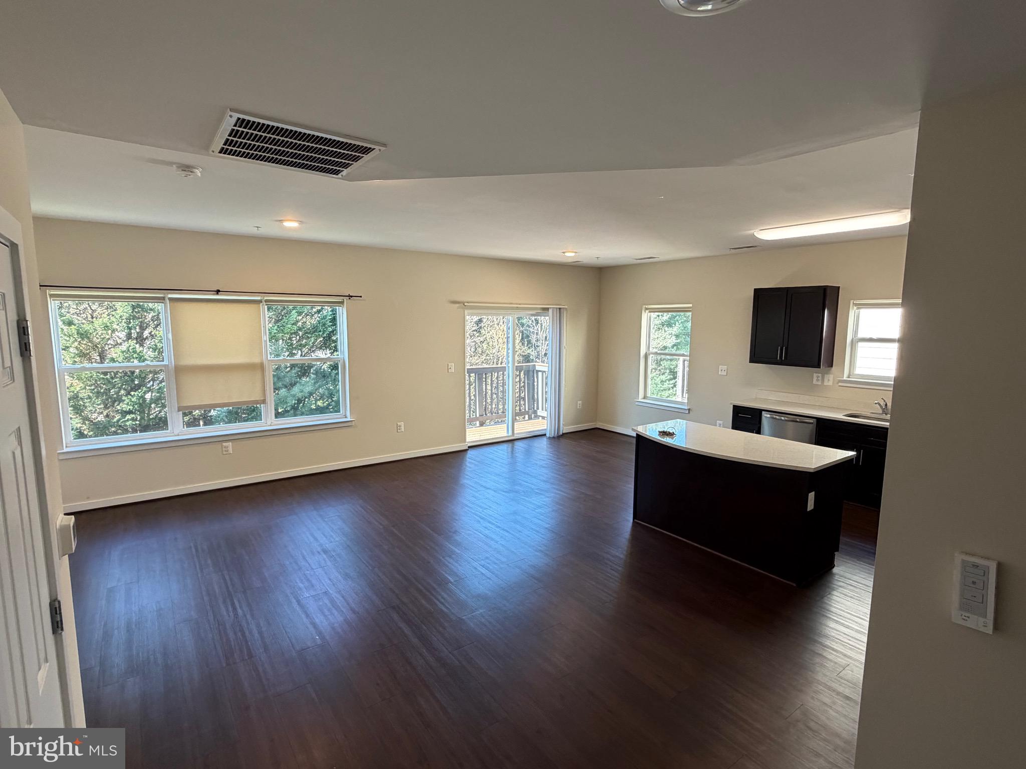 3303 Demirel Way, Unit D Ellicott City, MD 21042 - Photo 7 of 34 a view of room with wooden floor and windows
