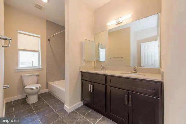 a bathroom with a sink toilet a mirror and vanity