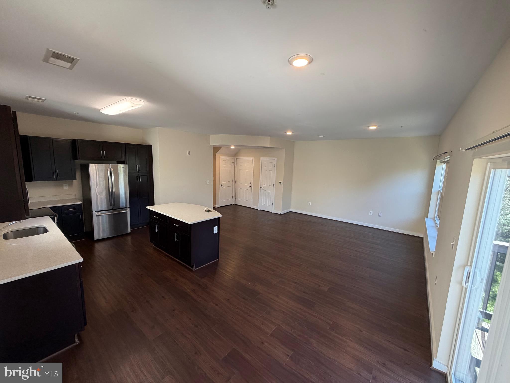 3303 Demirel Way, Unit D Ellicott City, MD 21042 - Photo 9 of 34 a living room with hard wood floors and furniture