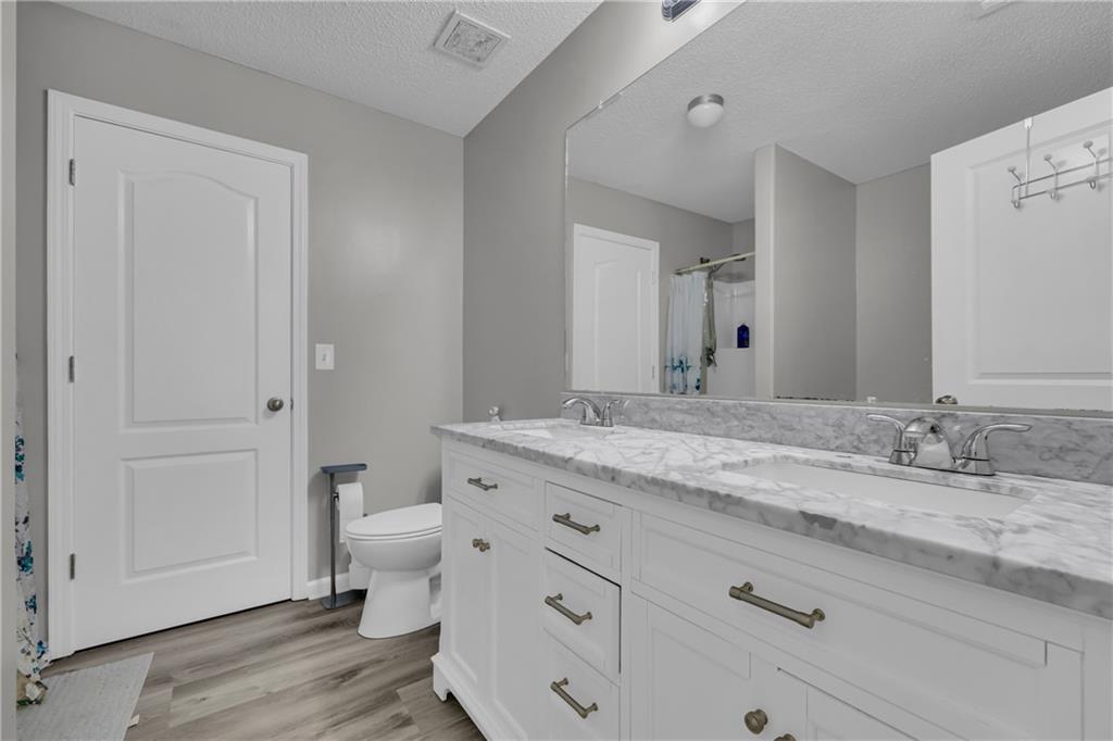 1498 Box Circle Winder, GA 30680 - Photo 36 of 56 a bathroom with a granite countertop sink mirror and toilet