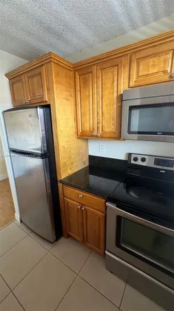 a kitchen with stainless steel appliances a stove and a microwave