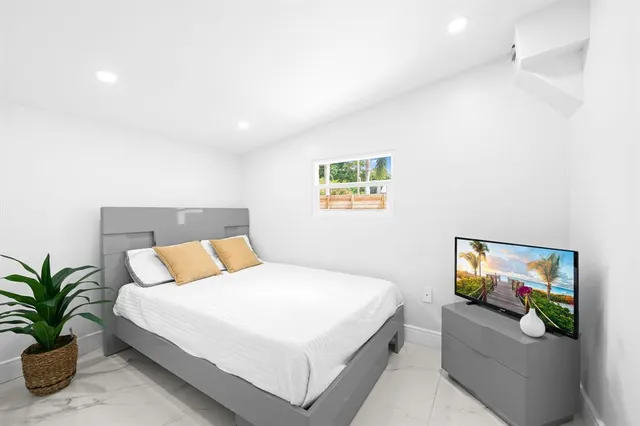 a bedroom with a bed and a painting on the wall