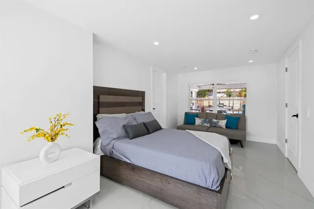 a bedroom with a bed and a couch