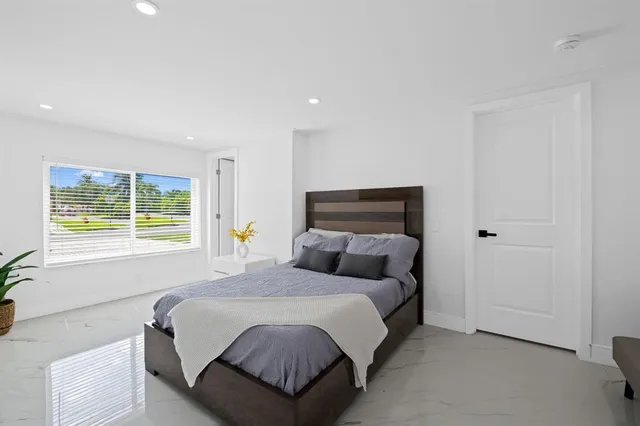 a bedroom with a bed and a window