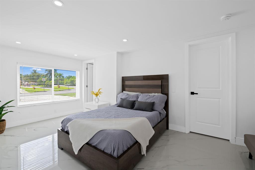 865 Northeast 23rd Terrace Pompano Beach, FL 33062 - Photo 18 of 33 a bedroom with a bed and a window