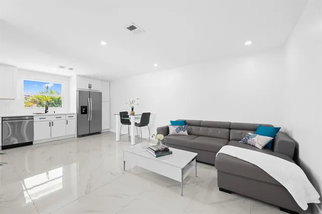 a living room with furniture and white walls
