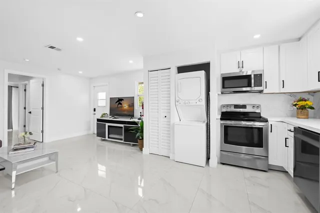 a kitchen with stainless steel appliances a stove top oven and a refrigerator
