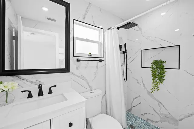 a bathroom with a sink and a mirror with toilet