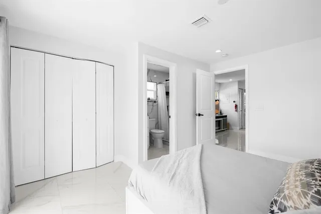 a bedroom with a bed and a walk in closet