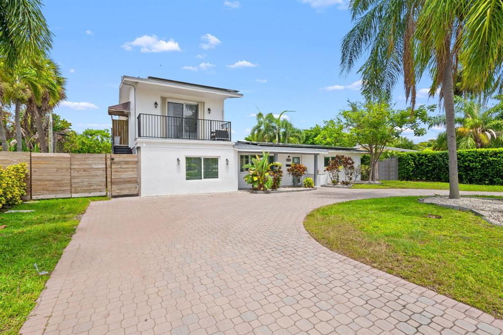 865 Northeast 23rd Terrace Pompano Beach, FL 33062 - Photo 5 of 33 a view of house with swimming pool and a yard