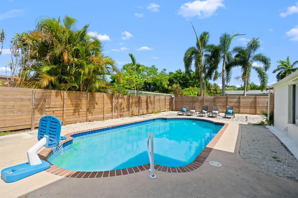 865 Northeast 23rd Terrace Pompano Beach, FL 33062 - Photo 6 of 33 a view of a swimming pool with a patio and plants