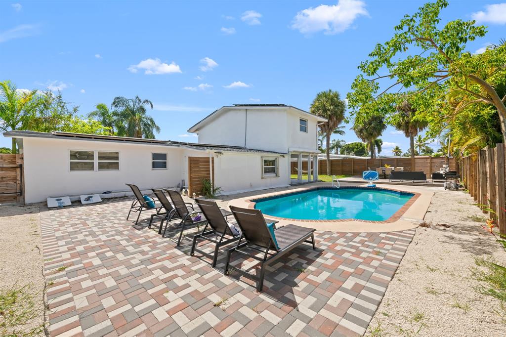 865 Northeast 23rd Terrace Pompano Beach, FL 33062 - Photo 7 of 33 a view of a house with swimming pool and sitting area