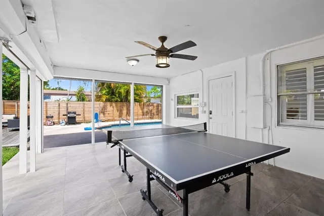 a kitchen with a table chairs and a chandelier