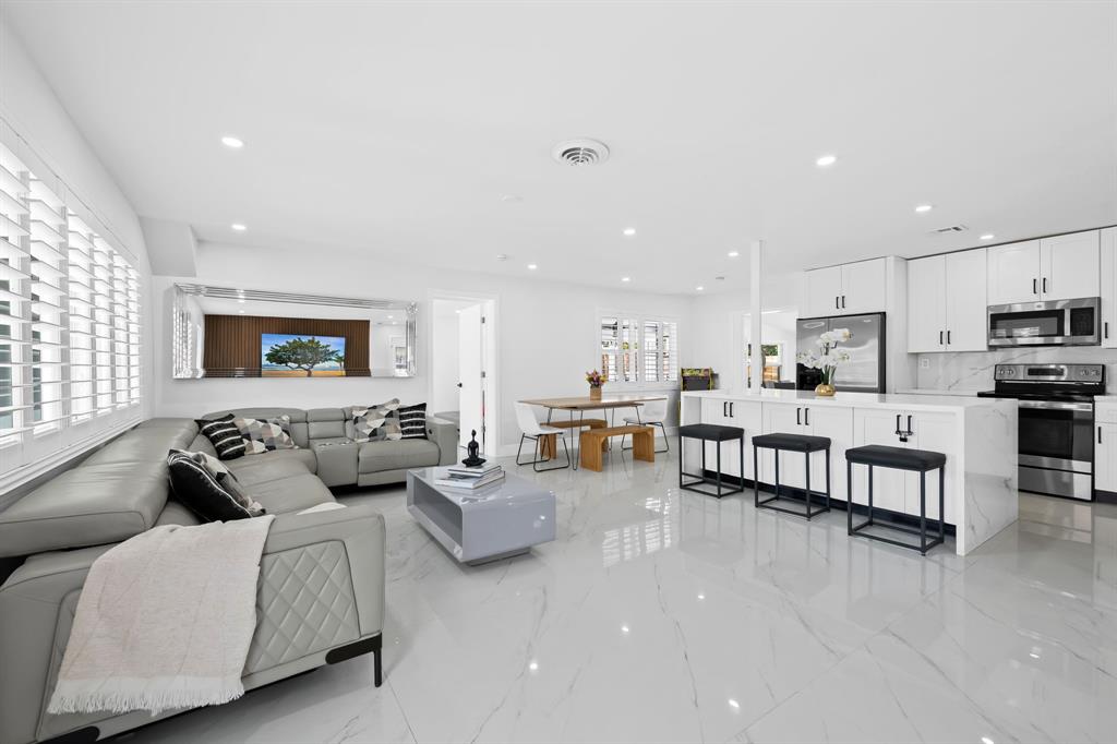 865 Northeast 23rd Terrace Pompano Beach, FL 33062 - Photo 10 of 33 a living room with furniture and kitchen view