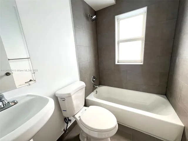 a white bath tub sitting next to a white toilet