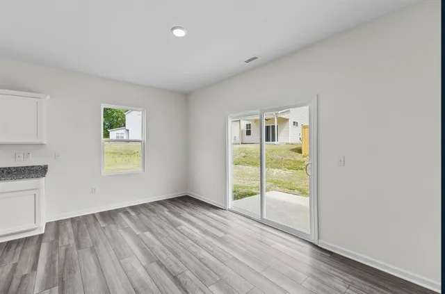 wooden floor in an empty room with a window