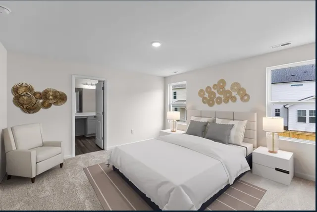 a bedroom with a white bed and a couch