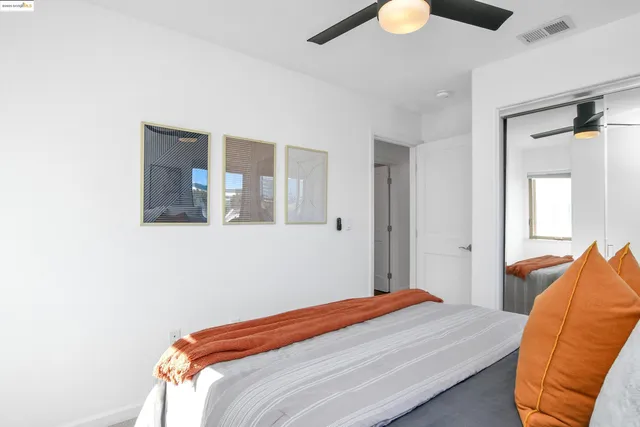 a bedroom with a bed and a large window