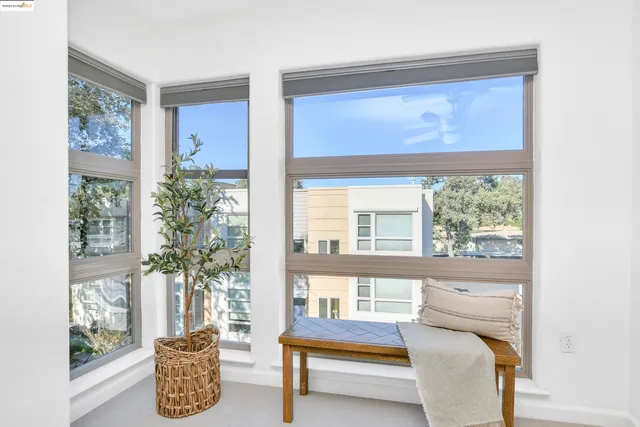 a bedroom with a bed and potted plant with table