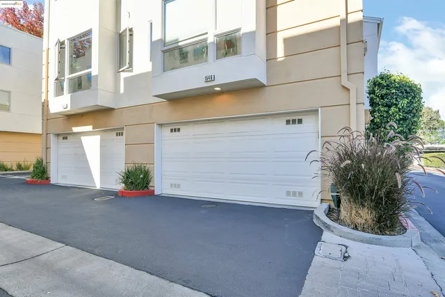 a view of a patio with table and chairs potted plants